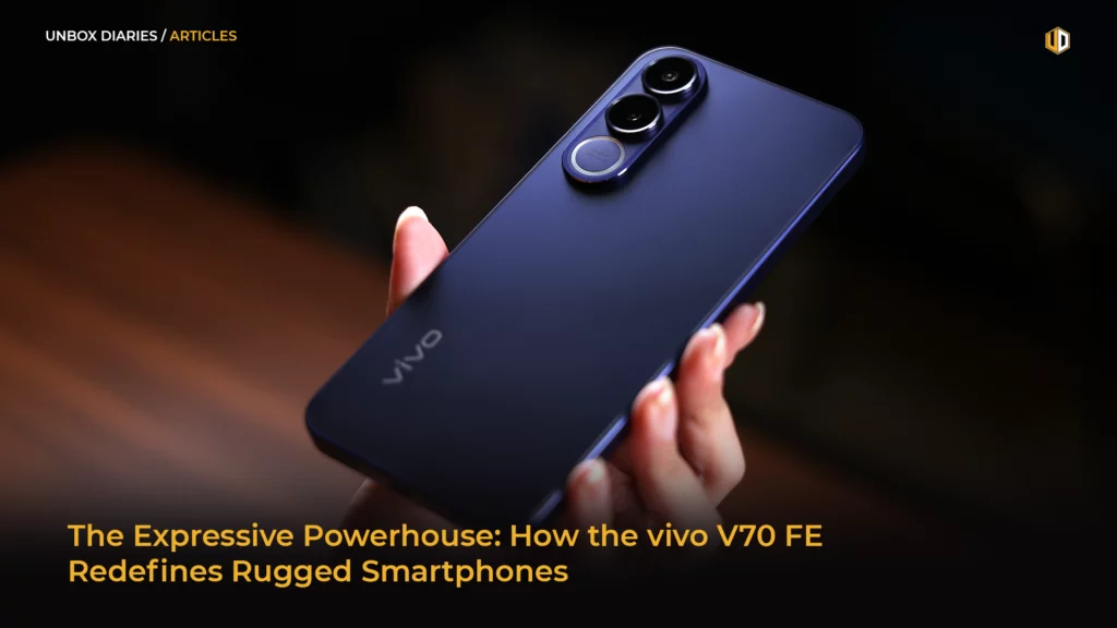 A person’s hand holding the vivo V70 FE at an angle, showcasing the smooth, matte purple finish and the prominent triple-camera module on the back. The lighting creates a soft gradient across the phone’s surface.