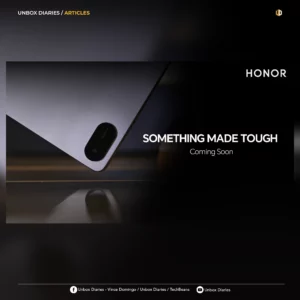 A promotional graphic for Unbox Diaries titled "ARTICLES." The image features a close-up, angled shot of the corner of a sleek, metallic grey tablet showing a pill-shaped camera module. To the right, the HONOR logo appears above the bold white text "SOMETHING MADE TOUGH" and "Coming Soon." The bottom of the frame includes social media handles for Unbox Diaries and TechBeans.