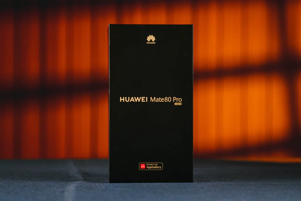 A front-facing studio shot of the HUAWEI Mate 80 Pro retail box. The box is minimalist black with the phone's name embossed in gold lettering and the Huawei logo at the top.
