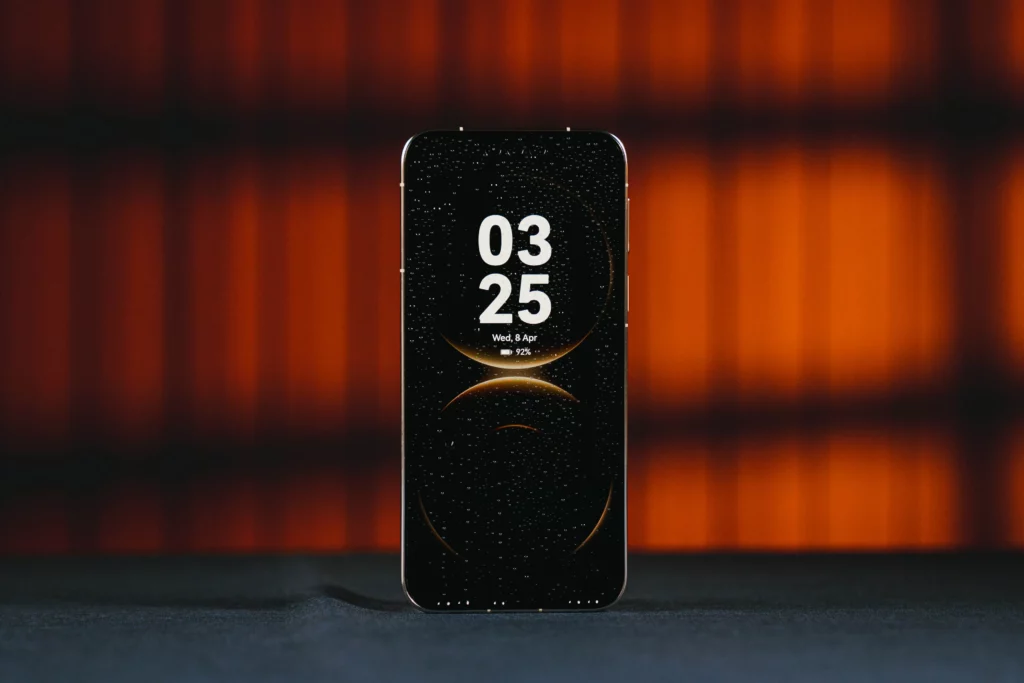 The device with the Always-On Display (AOD) active, showing a large digital clock (03:25) and a minimalist celestial wallpaper against a deep black background.