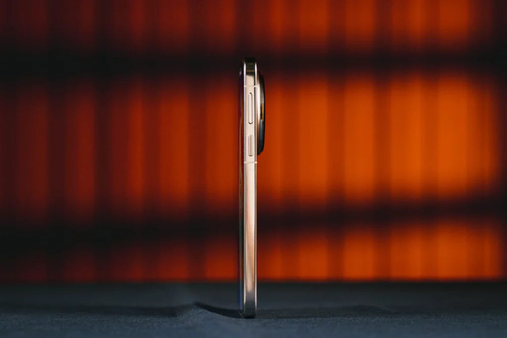 A side profile view of the phone, demonstrating its slim build. The camera module has a noticeable but tapered protrusion from the main body.