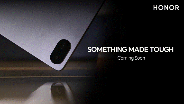 A high-resolution key visual (KV) for a new HONOR product. The shot focuses on the matte-finished back and rounded corner of a grey tablet, highlighting its slim profile and dual-lens camera island. On a solid black background to the right, the word "HONOR" is printed in white, followed by the centered tagline "SOMETHING MADE TOUGH" and "Coming Soon" in a smaller font.