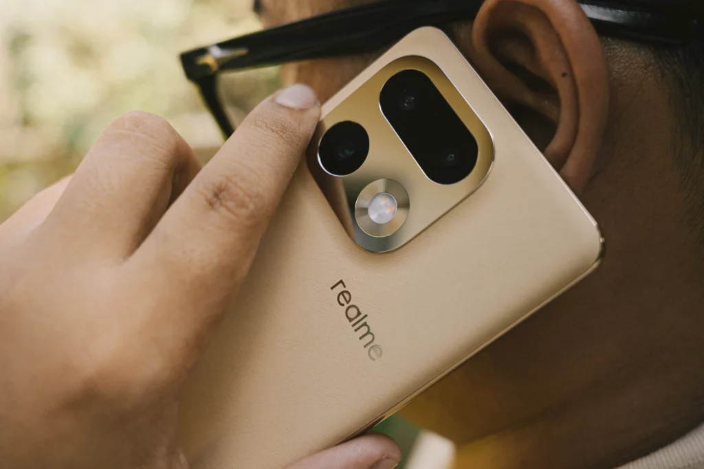 A person holding the realme 16 Pro+ 5G like it's being used for a phone call.