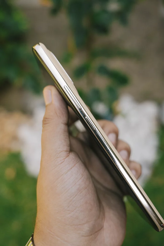 A hand holding the realme 16 Pro+ 5G showing its side profile.