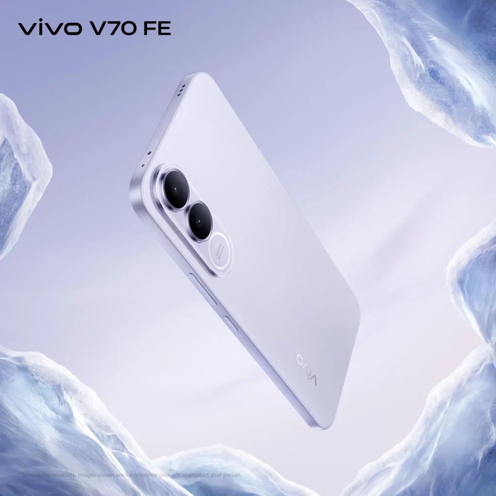 A sleek view of the vivo V70 FE in Urban Silver, angled to show its slim profile and metallic finish. The background features sharp, icy white formations, emphasizing a clean, "cool" aesthetic. The triple camera module is clearly visible on the upper left.