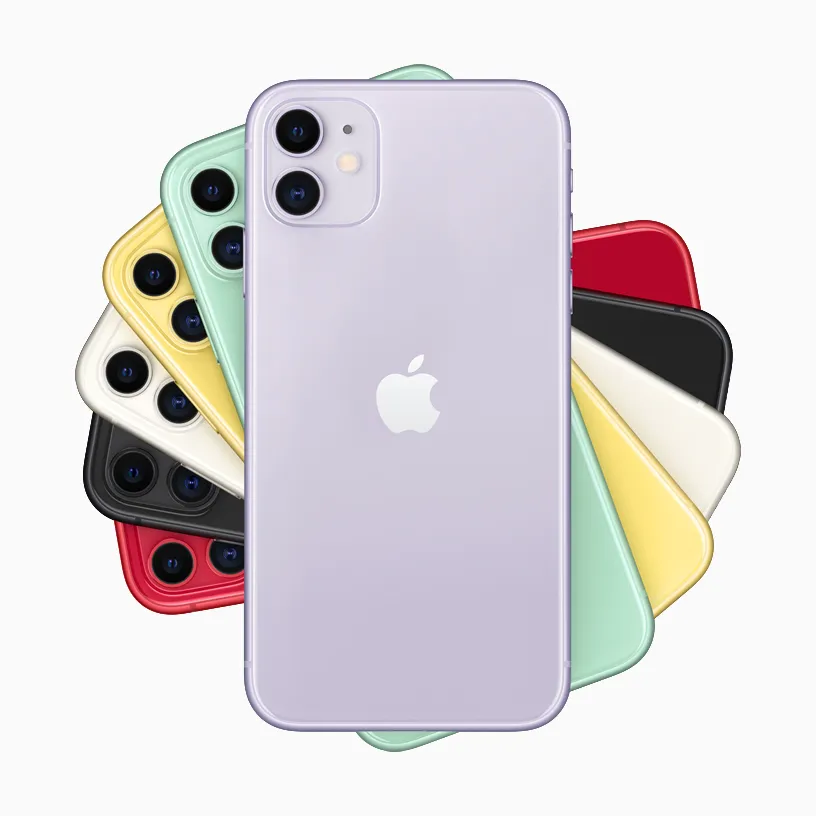 A collection of colorful iPhones arranged in a circular fan pattern against a plain white background. A lavender-purple iPhone is featured prominently in the center foreground, showing its dual-camera setup and the Apple logo on its back.