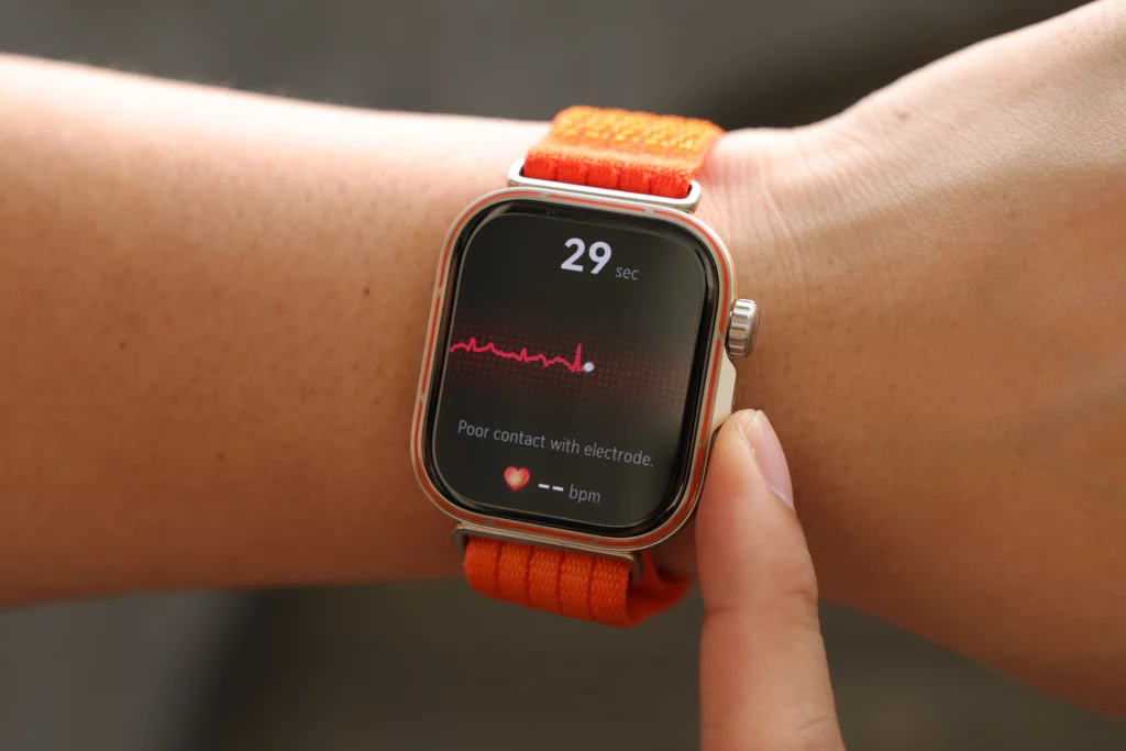 A person wearing the Huawei Watch Fit 5 Pro on their wrist, showing an ECG-style heart rate measurement screen that indicates "Poor contact with electrode."