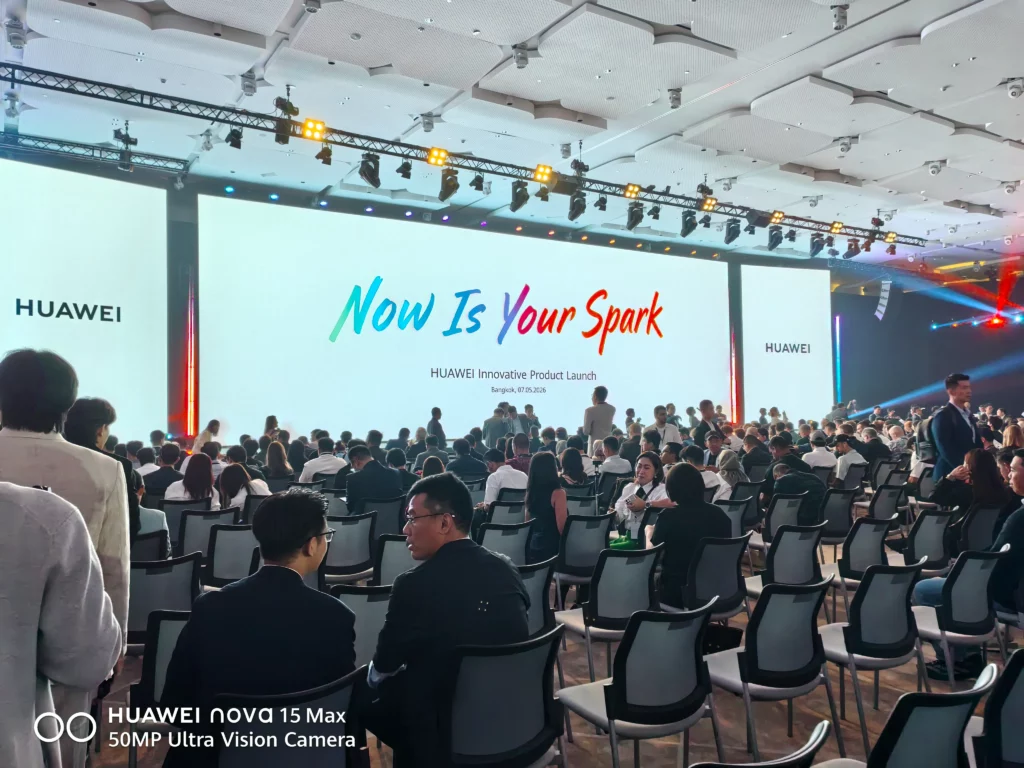A wide shot of a large audience seated in a dark auditorium, facing a bright stage screen that reads "Now Is Your Spark" for the HUAWEI Innovative Product Launch in Bangkok.