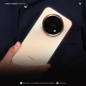 A square-format version of the Unbox Diaries article graphic. The image focuses closely on the champagne gold back panel and large circular camera module of the HUAWEI smartphone being held against a dark blue button-down shirt. The "UNBOX DIARIES / ARTICLES" branding is visible at the top, along with a small hexagonal logo in the top right. A dark gradient fades at the bottom to reveal a white footer with social media handles for Unbox Diaries, Vince Domingo, and TechBeans on Facebook and YouTube.