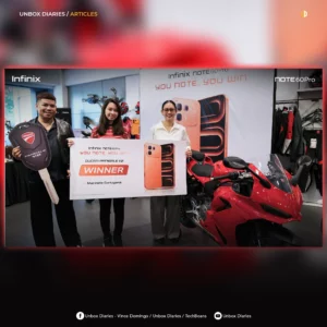 A social media graphic framed in red, showing three smiling representatives inside a showroom holding a large promotional "WINNER" board for Marinelle Cartagena. A man on the left holds a giant mockup of a Ducati key, and a bright red Ducati Panigale V2 motorcycle sits in the foreground on the right.