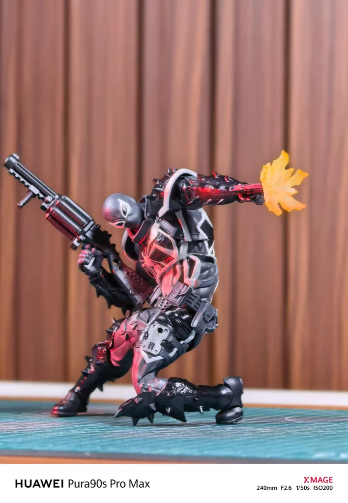 Detailed close-up shot of a black action figure in a battle stance showing intricate armor textures and lighting effects.