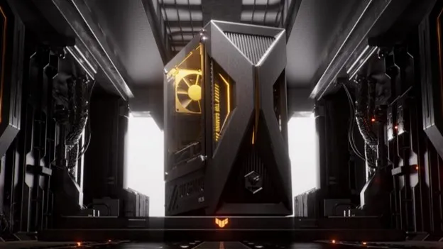 Compact ASUS TUF Gaming T700 Mini desktop PC showcased in a futuristic sci-fi corridor, displaying an angular grey front panel with an X-shaped design, side vents, and subtle yellow accent lighting.