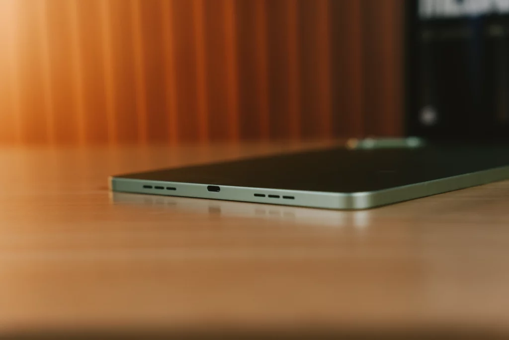Bottom edge view of the slim TECNO MEGAPAD 2 tablet featuring a USB Type-C charging port flanked by dual speaker cutouts.