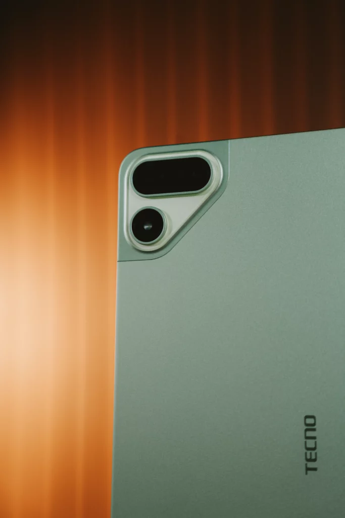 Close-up view of the unique triangular rear camera island on the light green TECNO MEGAPAD 2 tablet.