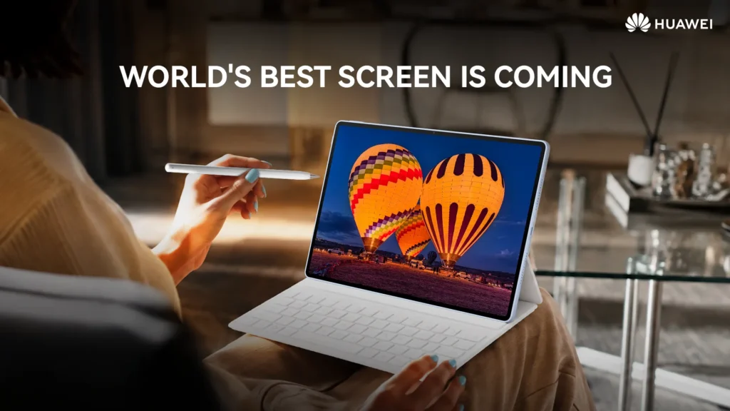 A person sitting indoors holding a white stylus while viewing vibrant hot air balloons displayed on the screen of a HUAWEI MatePad Air connected to a white keyboard base.