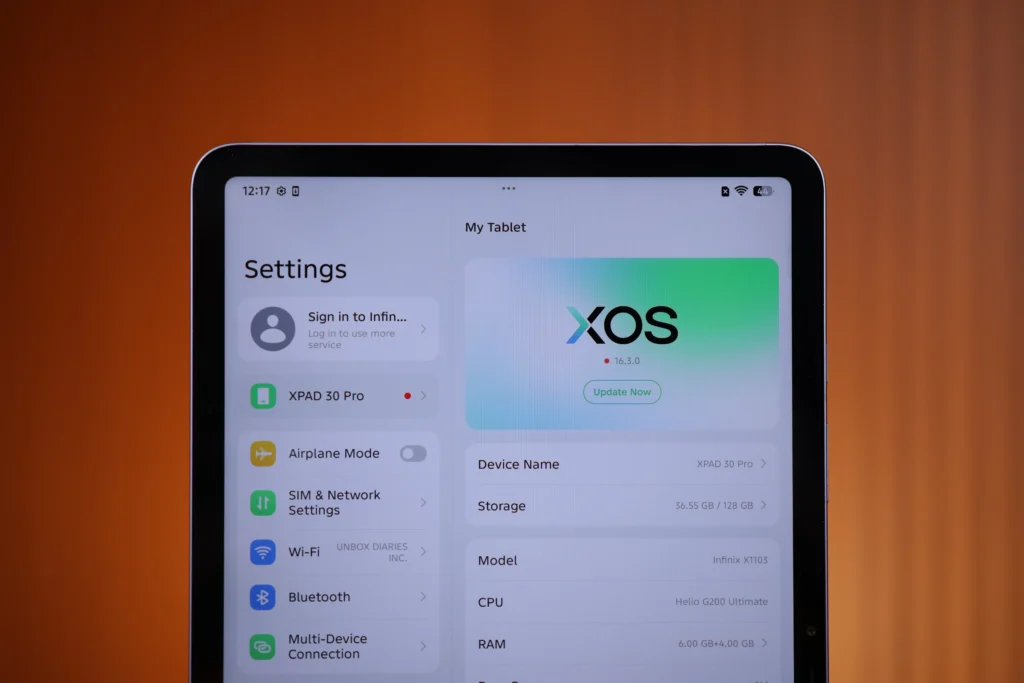 Close-up view of the Infinix XPAD 30 Pro screen showing the XOS Settings menu with device specifications, including model details, CPU, and RAM info.