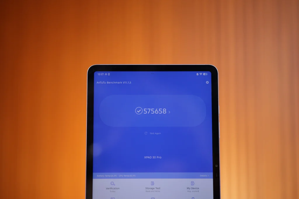 Front view of the Infinix XPAD 30 Pro display showing an AnTuTu Benchmark score result of 575658 on a blue user interface.