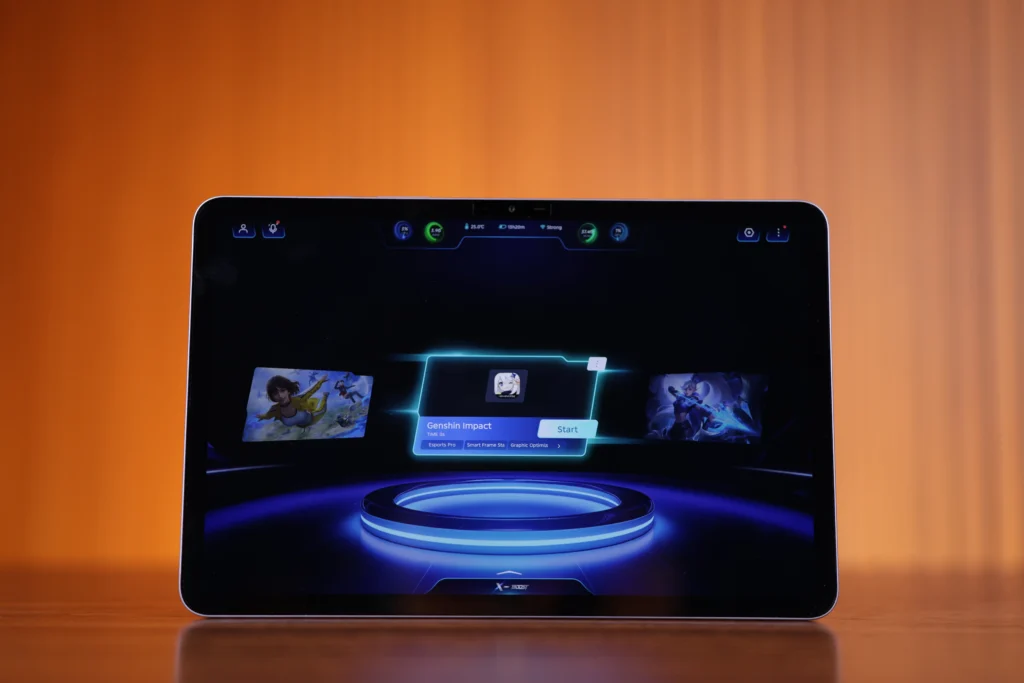Front view of the Infinix XPAD 30 Pro tablet displaying the X-Arena gaming launcher menu with a shortcut to launch Genshin Impact.