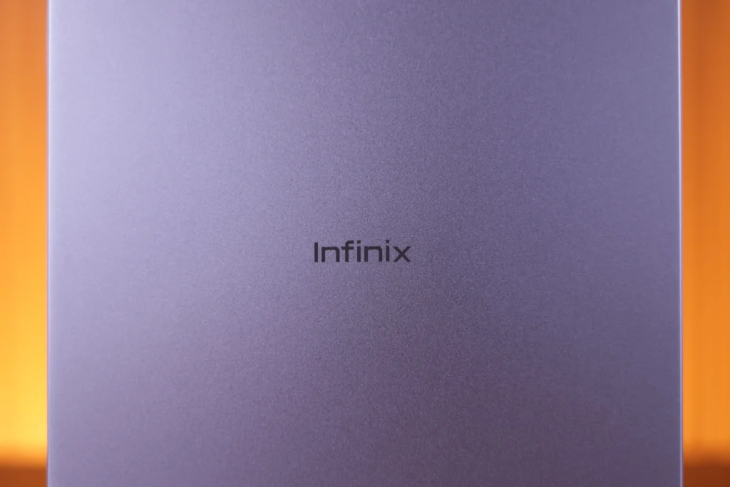 Close-up view of the metallic purple rear panel of the Infinix XPAD 30 Pro featuring the centered Infinix logo.