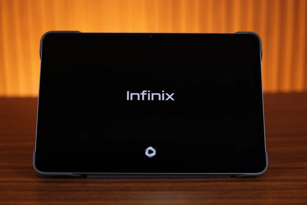 Front view of the Infinix XPAD 30 Pro screen inside a protective case, displaying the white Infinix bootup logo on a black display background.