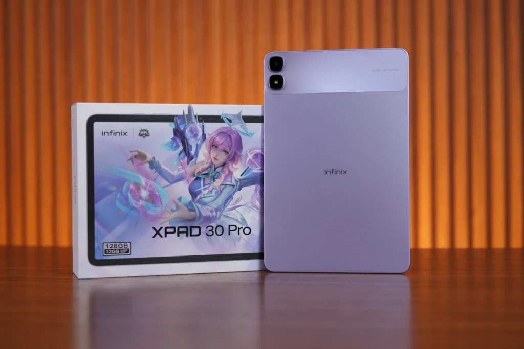 Rear view of the purple Infinix XPAD 30 Pro standing vertically beside its retail packaging box displaying gaming character artwork and specs.
