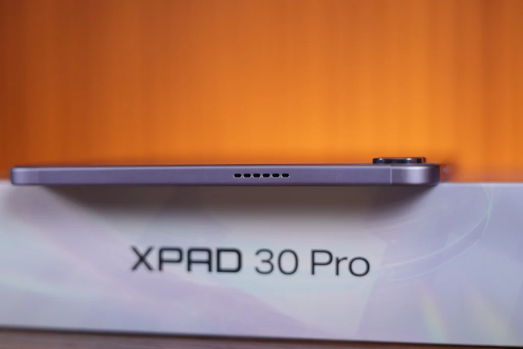 Top edge profile of the Infinix XPAD 30 Pro displaying its speaker ventilation holes along the frame.