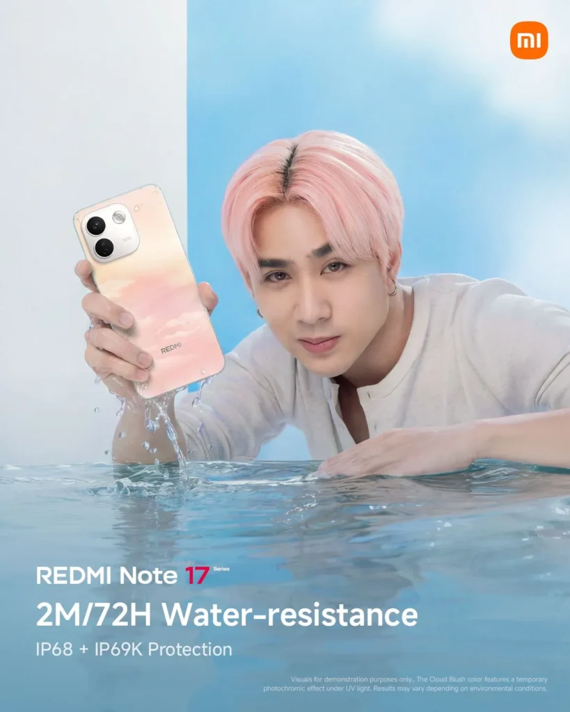 Josh from SB19, with pink hair and a light shirt, resting near water with droplets splashing around him. He holds up the REDMI Note 17 in a soft pink-and-yellow gradient finish. The overlay text highlights "REDMI Note 17 Series, 2M/72H Water-resistance, IP68 + IP69K Protection."