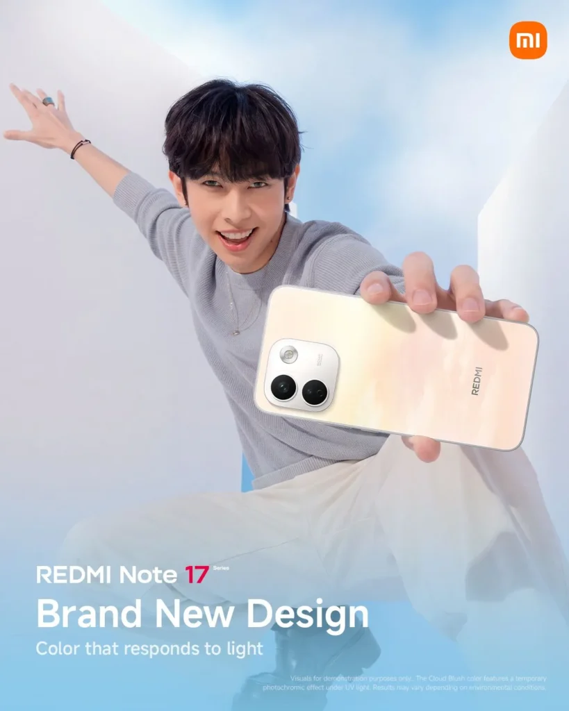Justin from SB19 leans dynamically toward the camera in a grey sweater and white pants, extending a light peach-colored REDMI Note 17 phone with a photochromic finish. Text at the bottom reads "REDMI Note 17 Series: Brand New Design - Color that responds to light."