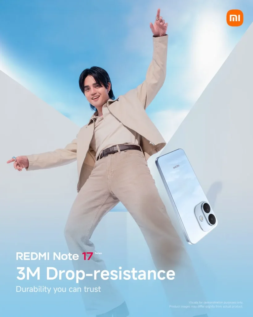 Pablo from SB19 poses in mid-air clad in a beige jacket and tan trousers against a blue sky, with a light blue REDMI Note 17 phone shown floating beside him. Prominent text at the bottom reads "REDMI Note 17 Series: 3M Drop-resistance - Durability you can trust."