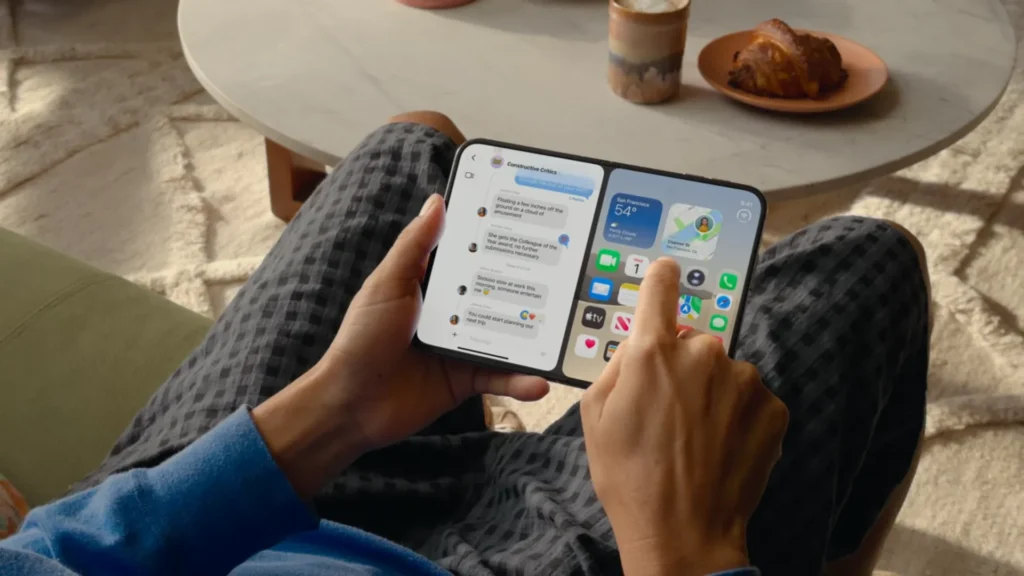 Person holding the unfolded device running split-screen multitasking, with a messaging conversation on the left and app widgets on the right.