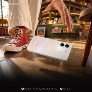 Close-up shot of the REDMI Note 17 Series smartphone falling mid-air, slipping from a person's hand onto a wooden floor near a red canvas sneaker, with Unbox Diaries branding overlaid.